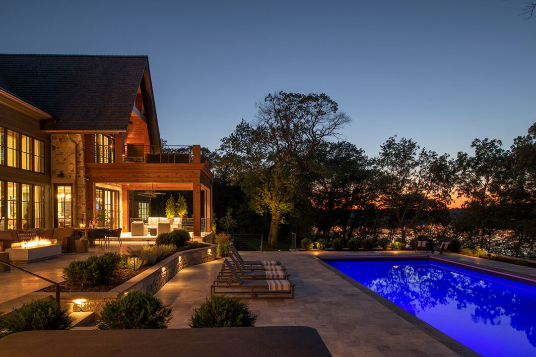 Pleasant-Lake-Home-at-Night-with-Outdoor-Lighting-the-Pool-and-Patios