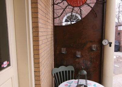 Metal Decorative Screen with Acrylic Sun to Screen a Minneapolis Alley